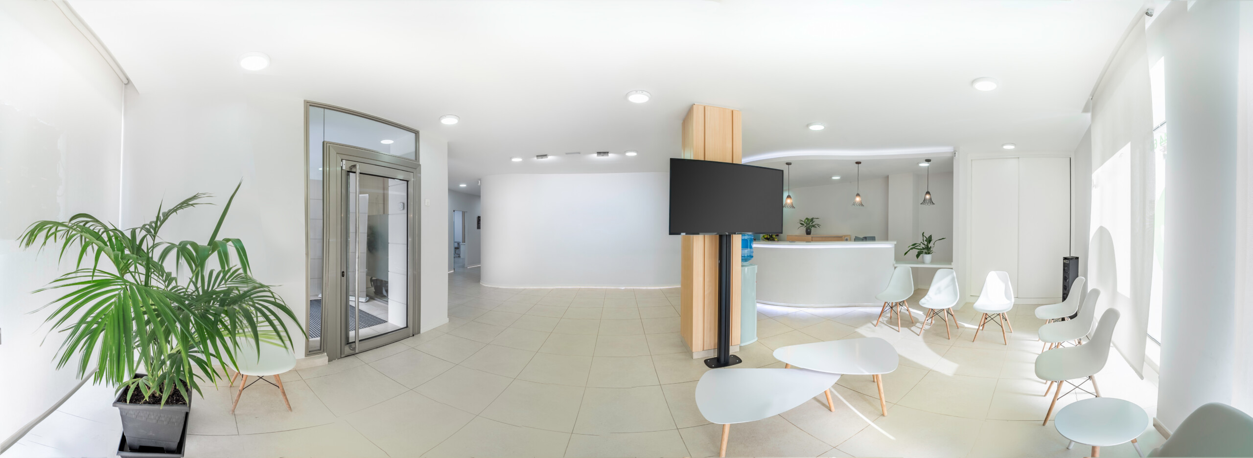 Panorama of a bright reception and waiting room in a clinic with